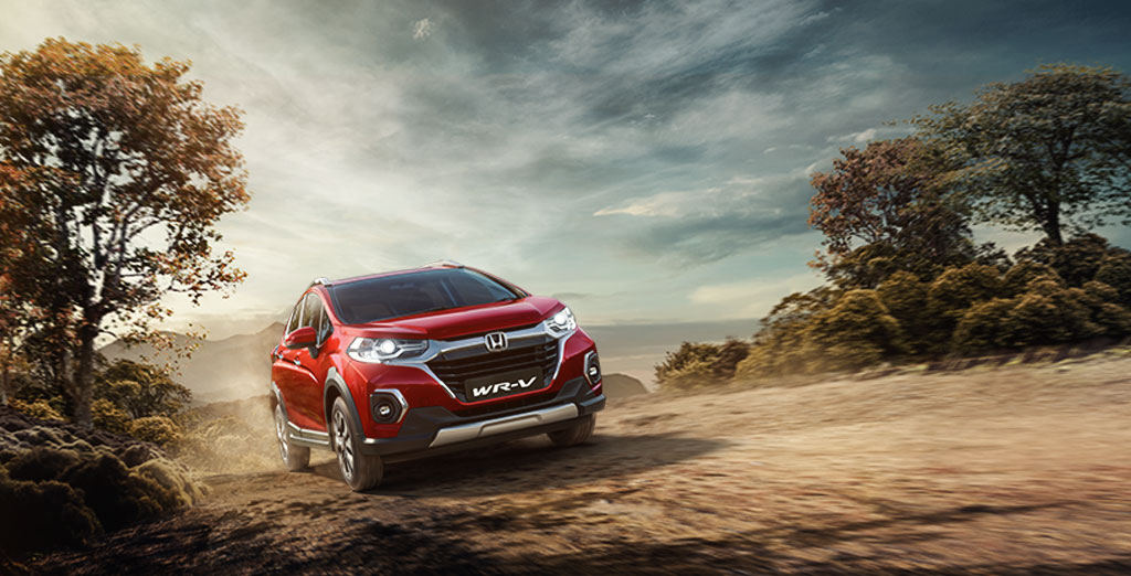New Red Colour Honda WRV Car on Dusty Road
