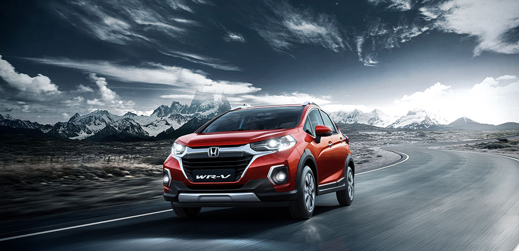 New Red Colour Honda WRV car on road with Mountains in Background